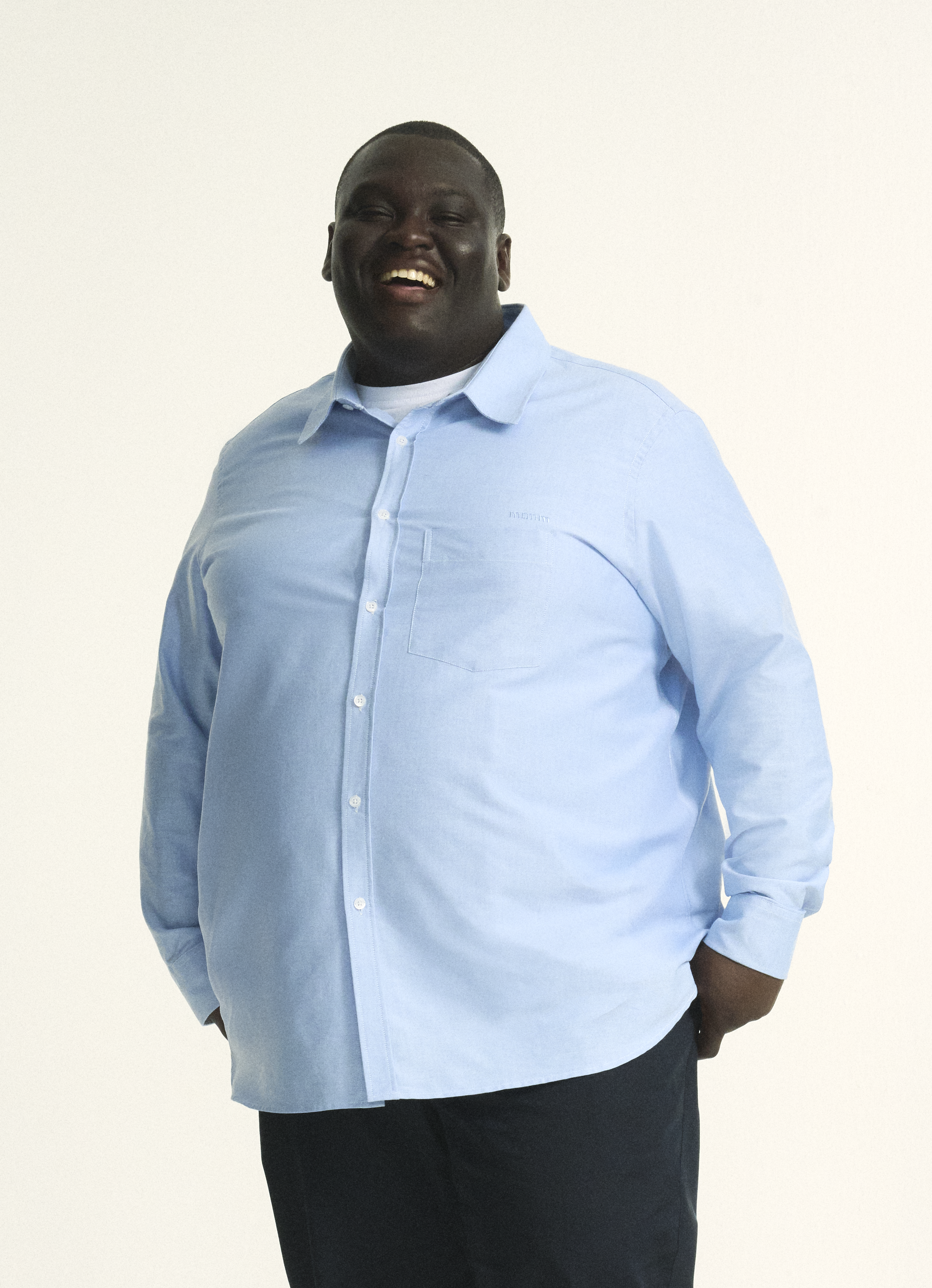 Model is wearing plus size menswear oxford shirt in Light blue. in size XL-5XL. Plus size regular fit navy menswear chino. Stretch chino for men in sizes XL–5XL (38–44) with comfort waistband for modern style.