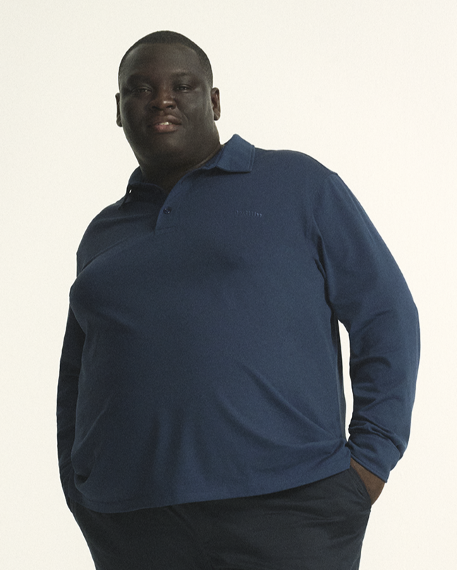 Model wearing The Cool-Fit Long Sleeve Polo in navy, combining style with moisture-wicking Coolmax® fabric