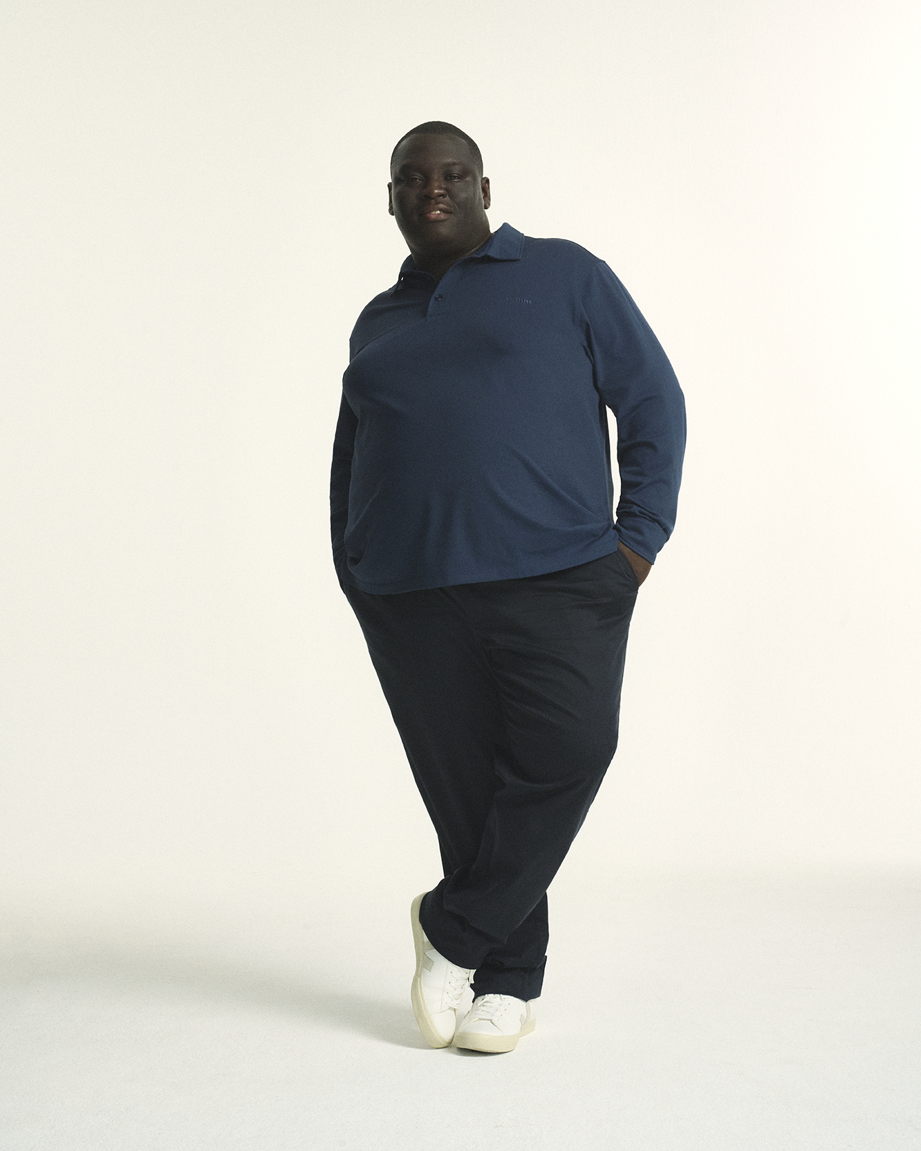 Model wearing Plus Size Long Sleeve navy Mens moisture-wicking Coolmax® Piqué Polo in sizes XL-5XL