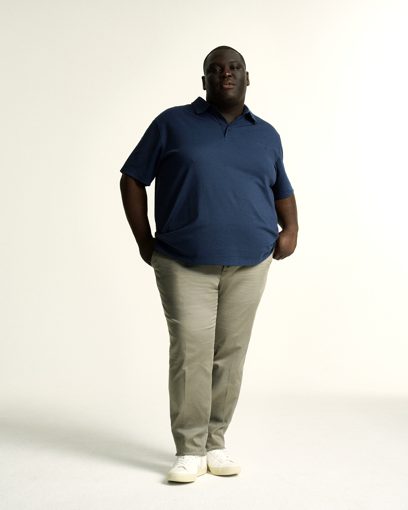 Model in The Cool-Fit Polo in Navy, featuring breathable Coolmax® fabric for moisture-wicking comfort