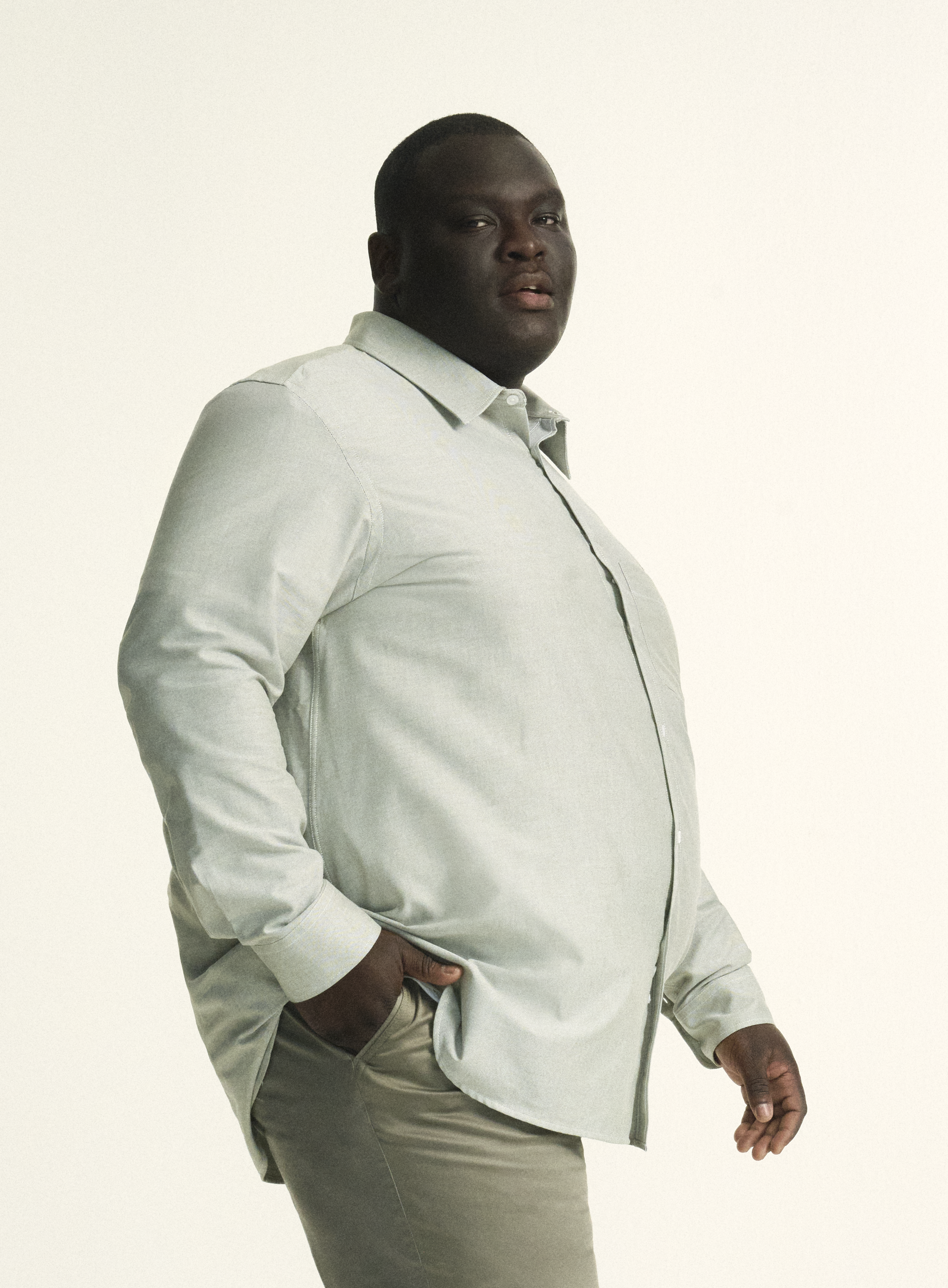 Model is wearing plus size menswear oxford shirt in khaki green, in size XL-5XL. Plus size regular fit khaki green menswear chino